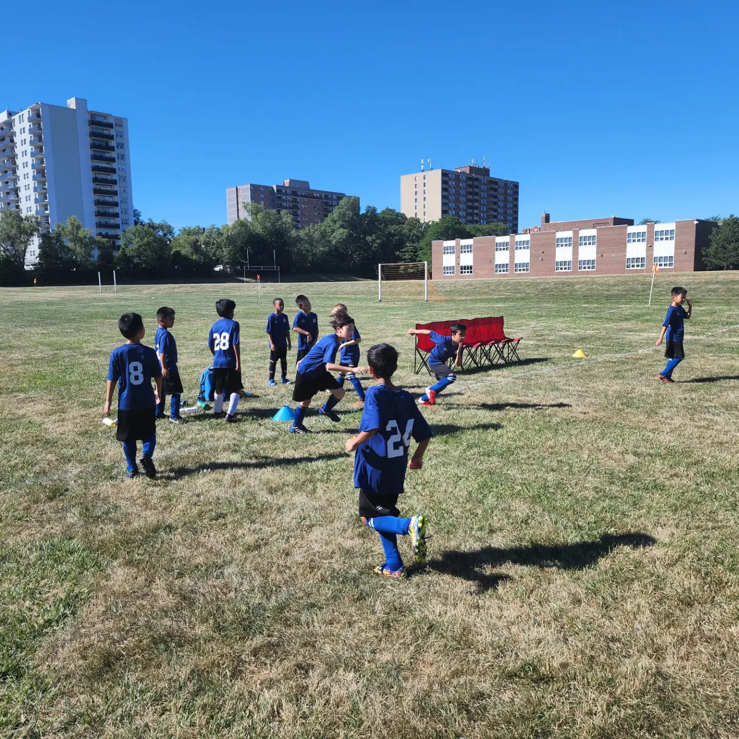 Development Group youth soccer players training outdoors with coach guidance