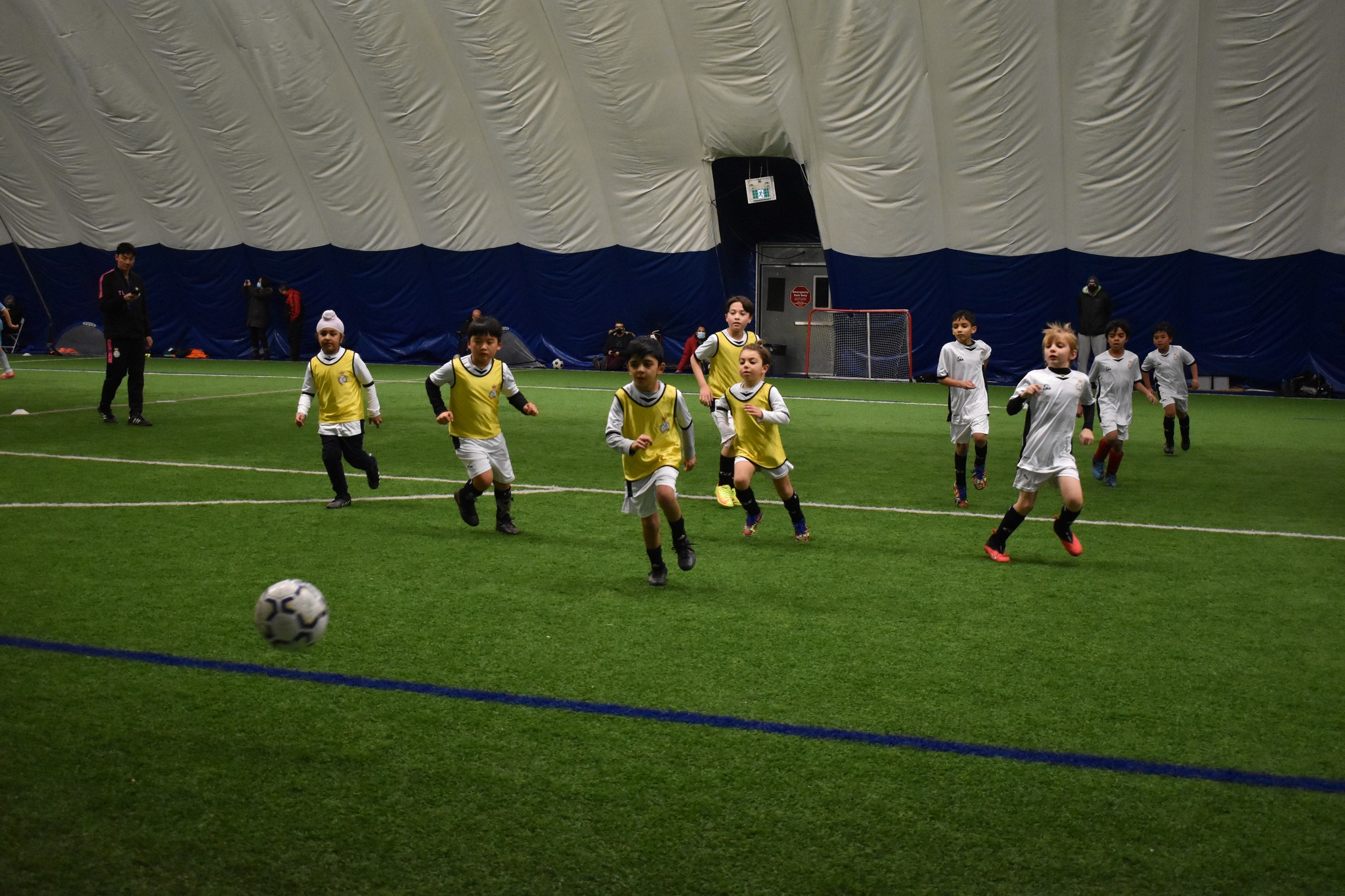 Children learning soccer indoors in winter season at Mississauga United FC