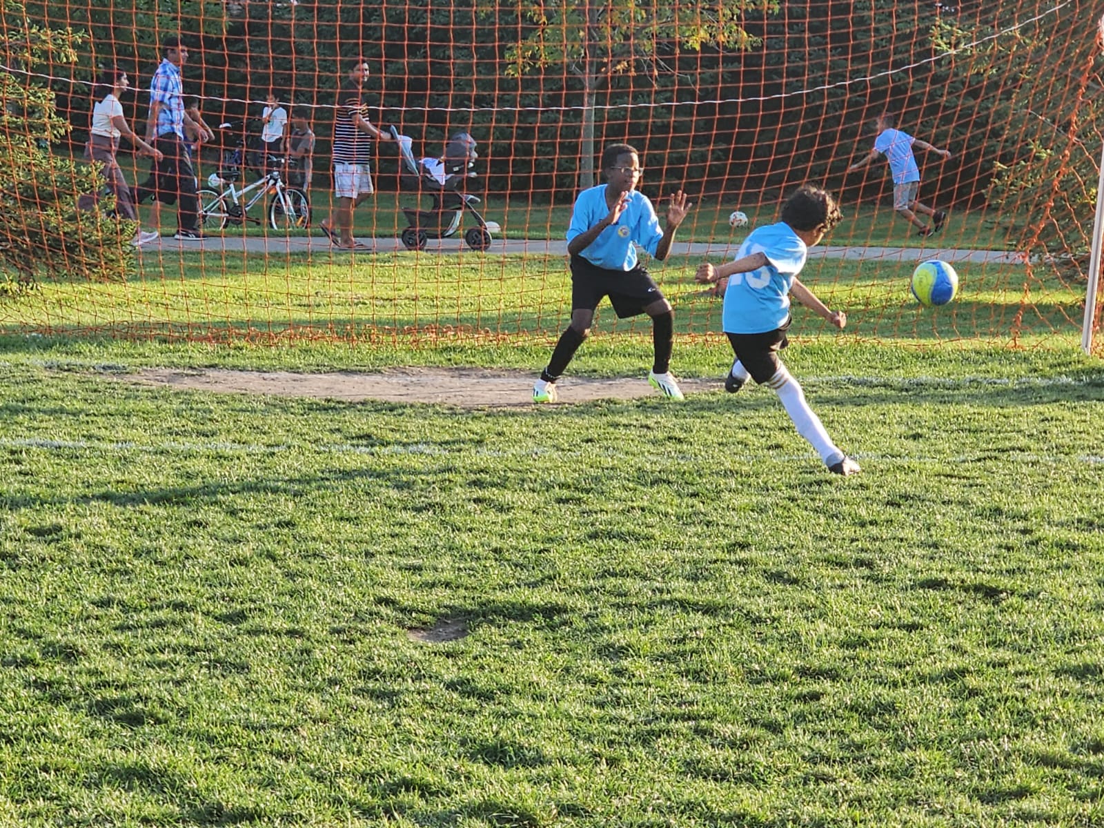 U12 rep soccer player taking a penalty kick during an outdoor match