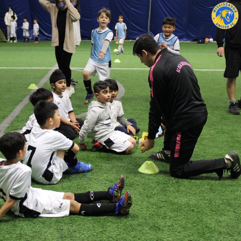 Coach instructing kids during an indoor Performance Program soccer training session in Mississauga