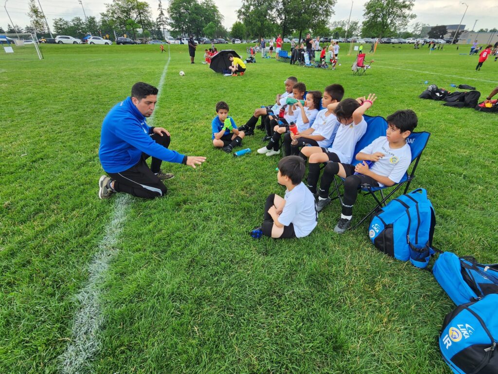 Young soccer players running during a game on a sunny field