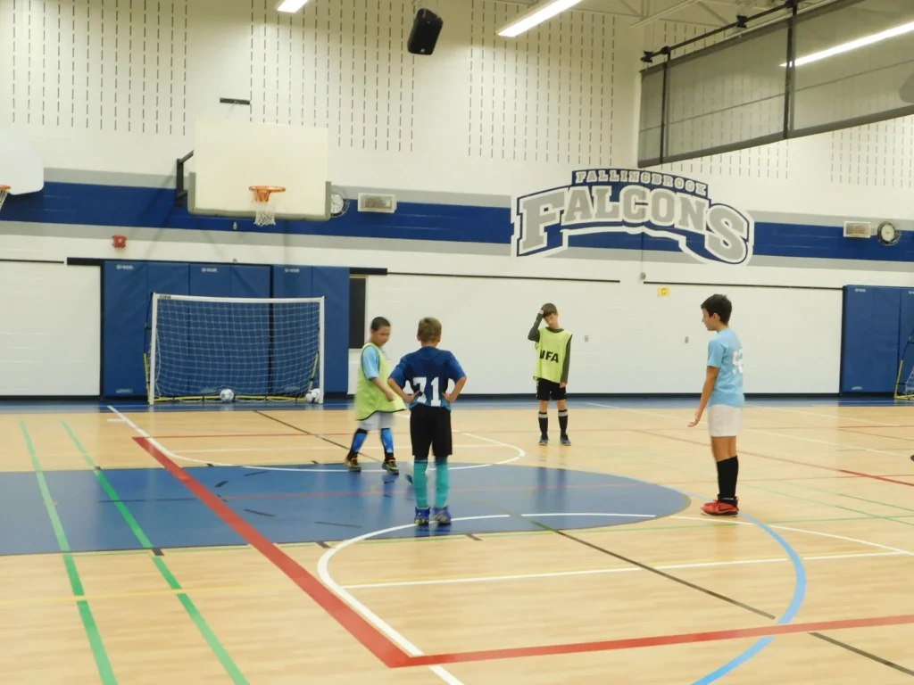 Coach instructing youth players during indoor soccer training in Mississauga’s Fall and Winter Soccer Program