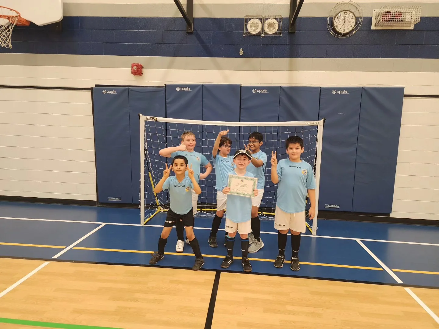 Youth goalkeepers standing in front of the net during goalie training at Mississauga United FC