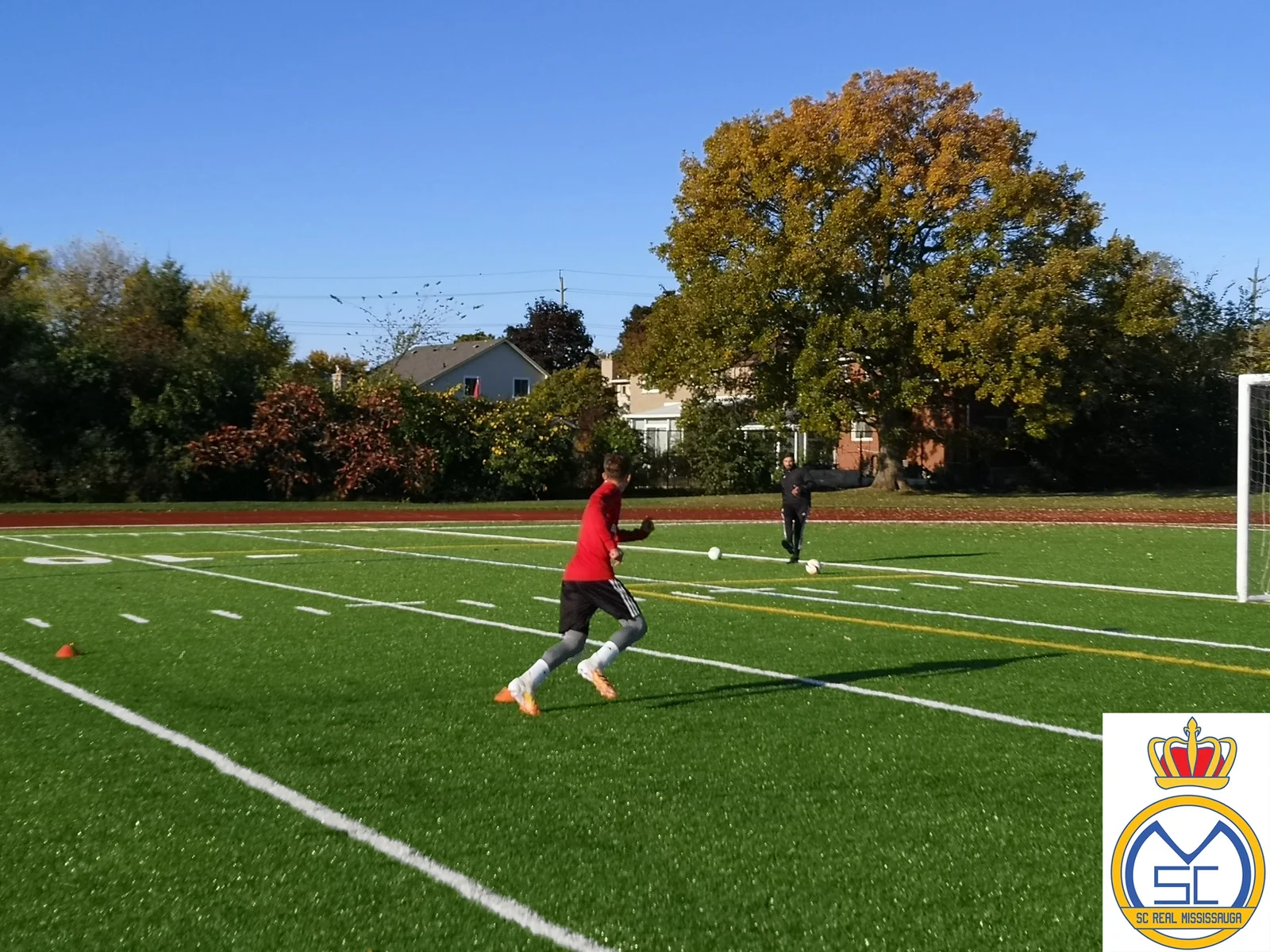 Coach giving one-on-one soccer instruction to a youth player in Mississauga