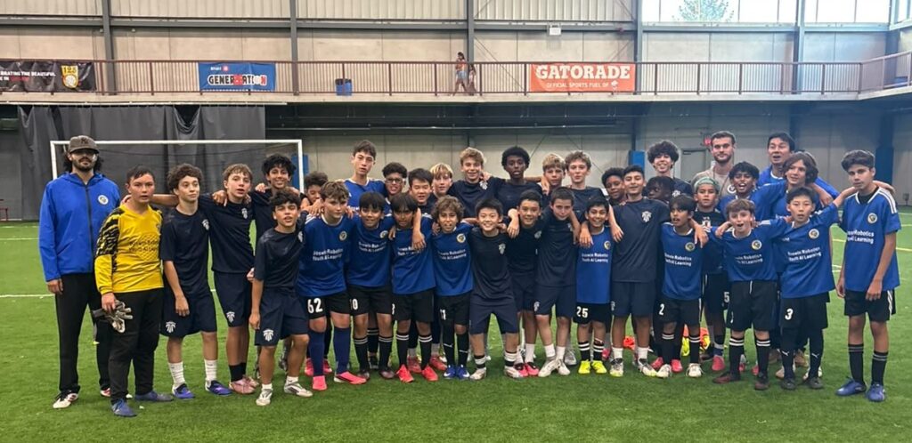 Mississauga United and Inter Toronto players and coaches pose together at the Ontario Soccer Centre.